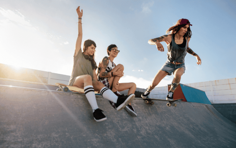 A group of women skateboarding in a skate park, performing tricks and enjoying the sport