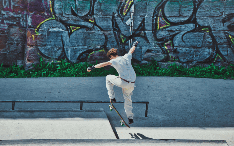 A skateboarder performing advanced tricks in a skatepark with ramps and rails