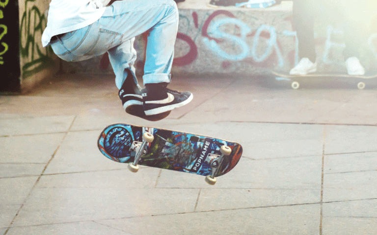 A skateboarder performs tricks in an urban setting, surrounded by graffiti, street art, and a diverse mix of people